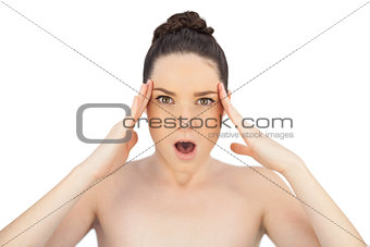 Shocked natural model touching her forehead