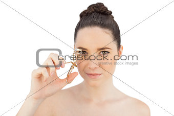 Sensual model using eyelash curler