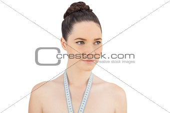 Pretty model with measuring tape on shoulders posing