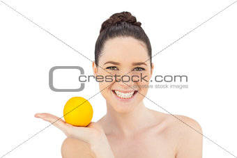 Smiling pretty model holding orange