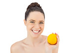Cheerful pretty model holding orange