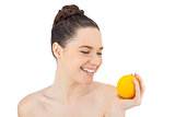 Happy pretty model holding orange