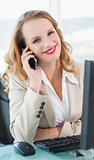 Content pretty businesswoman answering a phone call