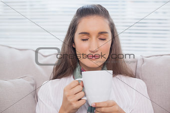 Relaxed pretty model smelling coffee