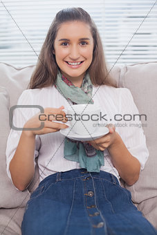 Happy pretty model holding coffee