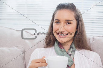 Cheerful pretty model holding coffee
