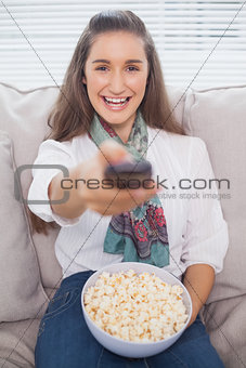 Cheerful cute model changing tv channel