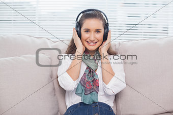 Smiling cute model listening to music