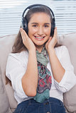 Smiling gorgeous model listening to music