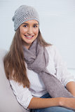 Cheerful attractive brunette with winter hat on posing