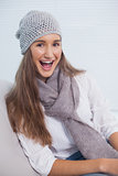 Smiling attractive brunette with winter hat on posing