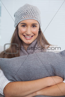 Happy attractive brunette with winter hat on posing