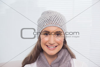 Cheerful brunette with winter hat on posing