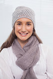 Smiling brunette with winter hat on posing