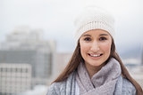 Smiling cute brunette with winter clothes on posing