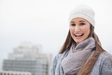 Cheerful cute brunette with winter clothes on posing