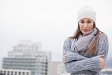 Shivering cute brunette with winter clothes on posing