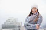 Cold cute brunette with winter clothes on posing