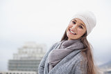 Smiling pretty brunette with winter clothes on posing