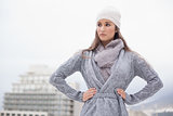 Serious pretty brunette with winter clothes on posing
