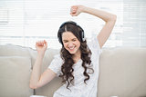 Pretty young woman dancing while listening to music