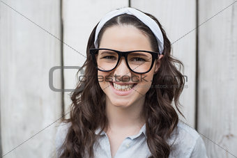 Cheerful trendy woman with stylish glasses posing