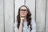 Pensive trendy woman with stylish glasses posing