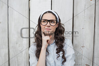 Pensive trendy woman with stylish glasses posing