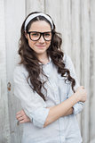 Peaceful trendy woman with stylish glasses posing