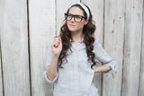 Artistic trendy woman with stylish glasses posing holding paintbrush
