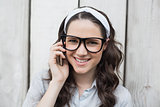 Smiling trendy woman with stylish glasses having phone call