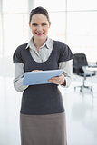 Cheerful businesswoman holding tablet pc