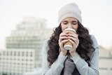 Pretty young brunette drinking coffee
