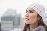 Pensive cute woman with winter clothes on posing
