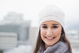 Smiling cute woman with winter clothes on posing