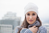 Cold cute woman with winter clothes on posing