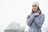 Cold pretty woman with winter clothes on posing