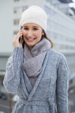 Cheerful gorgeous woman wearing winter clothes having a call