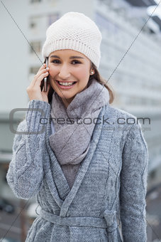 Cheerful gorgeous woman wearing winter clothes having a call
