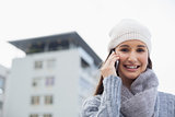 Happy gorgeous woman wearing winter clothes having a call