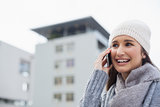 Happy gorgeous woman wearing winter clothes having a phone call