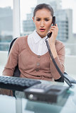 Furious businesswoman picking up the phone