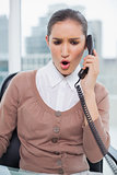 Angry businesswoman picking up the phone