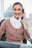 Cheerful businesswoman picking up the phone