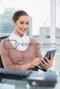 Cheerful businesswoman using her calculator