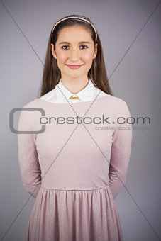Happy pretty model with pink dress on posing