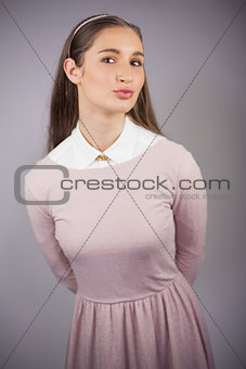 Happy young model with pink dress on posing