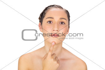 Natural model pointing at her chin