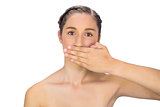 Unsmiling woman hiding her mouth