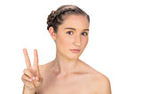 Relaxed woman making peace and love gesture